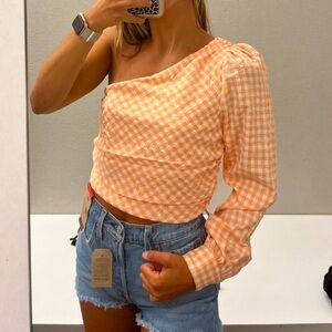 One shoulder orange and white top